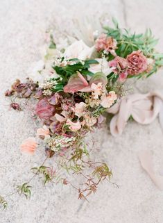 a bouquet of flowers is laying on the ground