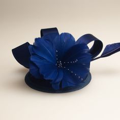 The Royal Blue fascinator pillbox hat - vintage, glamours and European inspired! The Royal Blue fascinator is about 5 inches wide & adorned with elegant royal blue ribbon, beading, feathering and a flower. An alligator clip at the base of the fascinator holds the piece in place. All of our items are handmade by a member of our shop. Our crowns, tiaras and jewelry are made of a thicker plating that contains real silver or gold and is nickel free. Our rhinestones are real European rhinestones Royal Blue Fascinator, Navy Blue Hat, Blue Fascinator, Mini Crown, Black Fascinator, Hat Wedding, Wedding Hat, Wedding Fascinators, Cocktail Hat