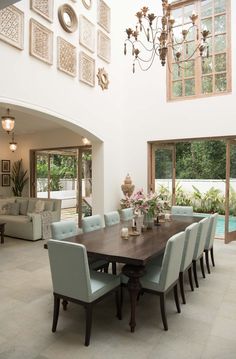 the dining room table is surrounded by blue chairs