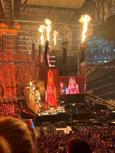 the stage is lit up with fire and people are watching