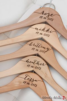 four wooden hangers with names on them