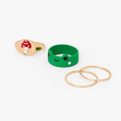 Add these cottagecore rings to to your jewelry party! This gold-tone set includes one red mushroom signet ring, a green frog band, and two woven bands. Pack Size: 4 Sizes Available: 7, 8, 9 Finish: Gold-tone Material: Metal - Claire's Green Frog, Red Mushroom, & Woven Band Ring Set (4 Pack) Cute Frog Stuff, Cottagecore Rings, Mushroom Accessories, Mushroom Stuff, Frog Stuff, Mushroom Ring, Mushroom Crafts, Bday Gifts, Red Mushroom