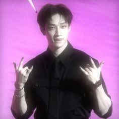 a man in black shirt holding up two fingers