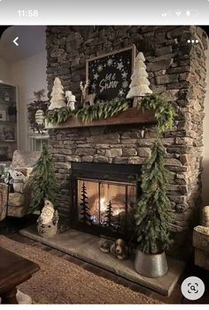 a fireplace decorated for christmas with evergreens and pine cones on the mantel above it