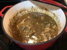 a pot filled with soup sitting on top of a stove