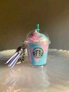 a starbucks drink with sprinkles and a keychain