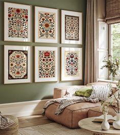 a living room filled with furniture and pictures on the wall above it's coffee table