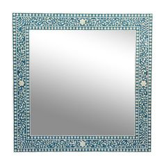 a blue and white mirror sitting on top of a wall