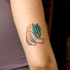 a woman with a cactus tattoo on her arm