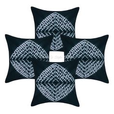 three black and white pillows with an abstract design on the front, two in the back