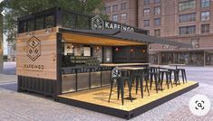 an outdoor bar with stools and tables in front of a large brown brick building