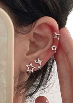 a woman with three stars on her ear