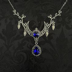 "This enchanting moon elf necklace features richly detailed antiqued silver tone filigree crescent, intricate leafy branches and elegant scroll drop accents. Its captivating design is adorned with dazzling dark sapphire blue glass crystals. Decorated portion is 4 1/2\" wide and 2 1/2\" tall in the very center.  Necklace length is adjustable with soldered stainless steel cable chain, lobster clasp and extender. If you would like a different length, please send us a message. Matching headpiece, pendant and earrings are listed separately in our store. If you don't see items with a color you want, feel free to ask about availability." Silver Bohemian Jewelry For Fantasy Events, Fantasy Jewelry Necklace, Elf Necklace, Blue Crescent Moon, Moon Elf, Moon Accessories, Filigree Necklaces, Dark Sapphire, Jeweled Earrings