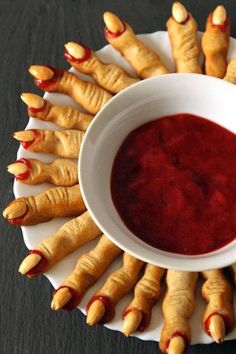 a white bowl filled with red sauce on top of a plate