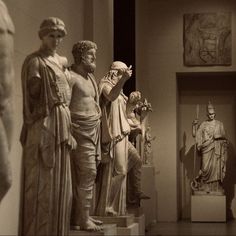 the statues are all lined up in an art museum