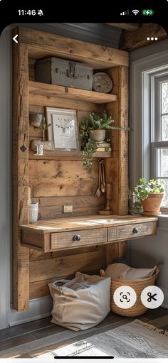 a wooden desk sitting in front of a window next to a basket filled with plants