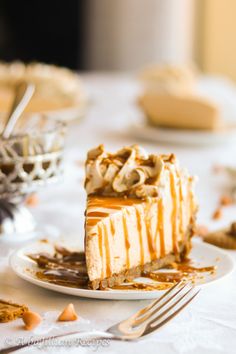 a slice of cheesecake on a plate with caramel drizzle