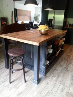 a wooden table with black chairs around it