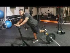 a man doing push ups on a bar in a gym