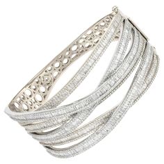 The Following Item we are offering is this Beautiful Rare Important 18KT Gold Sparkling Bangle Bracelet. Bracelet features an Array of Magnificent Rare Assorted Gorgeous Fancy Tapered Cut Diamonds. T.C.W. Approx 10.50Carats!!! The Diamonds are of Beautiful Fine Quality. This Gorgeous Bangle is a Rare Sample Piece From a Top Private Manufacturer that sold to select Five Star Hotel and Fine Jewelry Stores and comes with a Gemological Certificate. NWT Retail $67,500!! Luxury Diamond Cut Bracelet For Evening, Elegant White Gold Bangle With Baguette Diamonds, Luxury Bangle With Baguette Diamonds, Luxury Evening Bracelets With Baguette Diamonds, Luxury Baguette Diamond Bangle For Formal Events, Luxury Sparkling Diamond Bracelet, Luxury Sparkling Diamond Bangle Bracelet, Luxury Sparkling Diamond Bracelet For Formal Occasions, Luxury Sparkling Diamond Bracelet For Anniversary