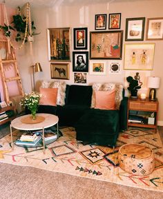 a living room filled with furniture and pictures on the wall