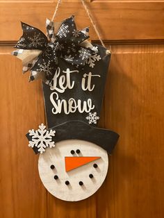 a snowman door hanger that says let it snow