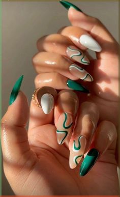 Channeling the vibrant energy of spring meadows, these nails are a work of art. Bold emerald strokes dance across a backdrop of creamy almond, creating a juxtaposition that’s both striking and serene. Each nail is a unique canvas, with abstract lines that flow like the rivulets of a tranquil stream. This design takes the concept of nail ideas into the realm of personal expression, where each nail becomes a testament to individuality and flair. Agust Nails 2024, Bottega Veneta Lido Sandals Outfit, Ferxxo Nails, Green Nails Art, Bold Nail Art, Kutek Disney, Lilac Nails, 2024 Nails, Abstract Nail Art