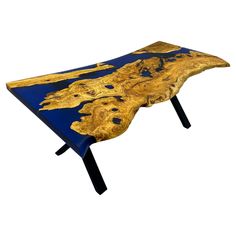 a wooden table with blue and gold paint on it