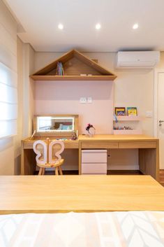 a room with a bed, desk and shelves