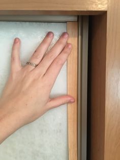 a person's hand on top of a drawer with their left hand in it