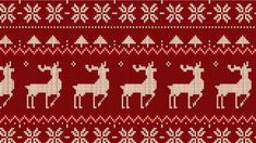 a knitted christmas sweater with deers and snowflakes on red background photo