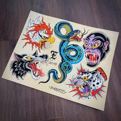 an old school tattoo design on a piece of paper with some animals and snakes around it