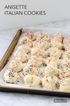 white cookies with sprinkles on a baking sheet