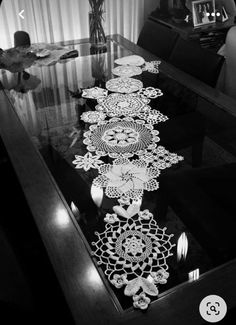 the table is made out of glass and has intricate designs on it, as well as flowers