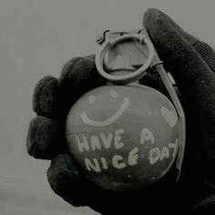 a hand holding a ball with the words have a nice day written on it and a pair of scissors