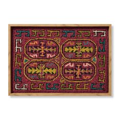 a red rug with colorful designs on it