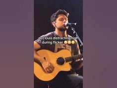 a man holding a guitar in front of a microphone with the caption, not louis distracting mail during flickerer