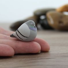 a small bird sitting on top of a persons hand