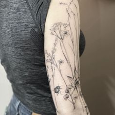 a woman with a flower tattoo on her arm