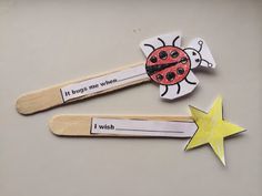 two wooden clothes pins with ladybugs on them and a star next to it