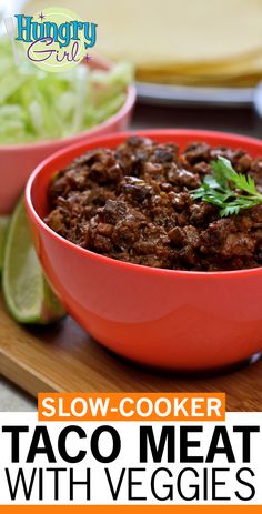 slow - cooker taco meat with veggies in a red bowl on a cutting board