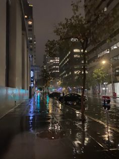 a city street at night with rain on the ground