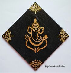 an intricately designed black and gold cloth with the image of ganesh on it