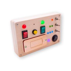 a wooden toy with buttons and knobs on it