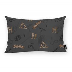 the harry potter pillow is shown on a gray background with gold lettering and hogwart symbols