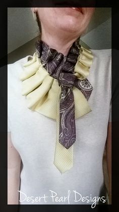 a woman wearing a white shirt with a black and yellow neck tie on her neck