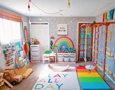 a child's playroom with toys and rainbow rugs on the floor in front of it