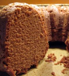 a loaf of bread sitting on top of a table next to a slice of cake