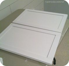 two white cabinet doors sitting on top of a counter