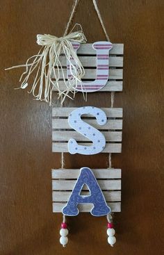 a wooden sign hanging from the side of a wall with letters and numbers on it